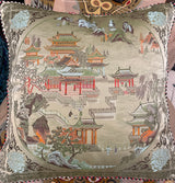 Decorative pillow with intricate patterns and colors on a textured surface